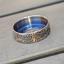 Close-up of the Wowsers DAMAS LOTR titanium beauty ring engraved by Laser Custom Works