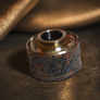 Close-up of Dragon engraved titanium cap in premium titanium