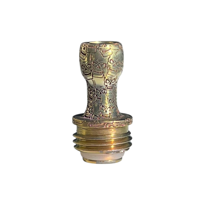 A titanium Boro drip tip colored in gold with agressive Bart skulls